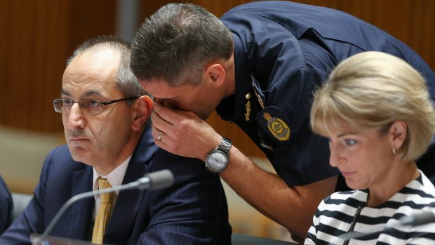 Department of Immigration and Border Protection secretary Michael Pezzullo and Australian Border Force commissioner Roman Quaedvlieg in discussion during an estimates hearing at Parliament House.