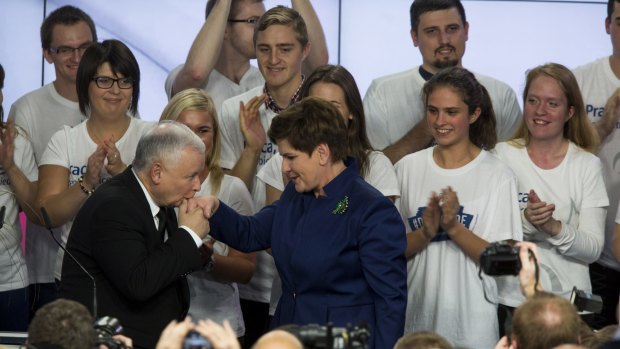 Jaroslaw Kaczynski, leader of the opposition Law and Justice Party (PiS), left, greets Beata Szydlo, deputy chairman of the opposition party and candidate for prime minister, after victory in the Polish general election in Warsaw.