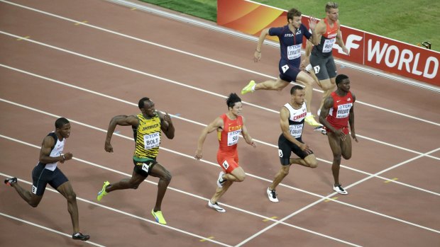 Jamaica's Usain Bolt (second left) looks across as he goes all out to win his 100m semi-final at the World Athletics Championships in Beijing on Sunday.