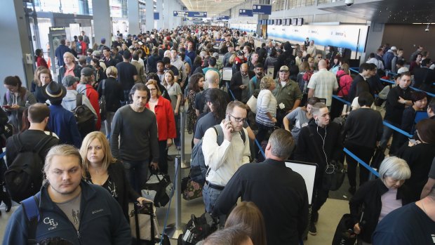 Passengers at O'Hare International Airport wait in line to be screened at a Transportation Security Administration (TSA) checkpoint in Chicago, Illinois. Waiting times at the checkpoints were reported to be as long 2 hours. The long lines have been blamed for flight delays and a large number of passengers missing flights completely.