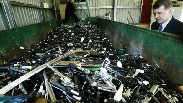 Then NSW police minister John Watkins looks at thousands of handguns handed in for the gun amnesty and the gun buy back scheme in 2004.  