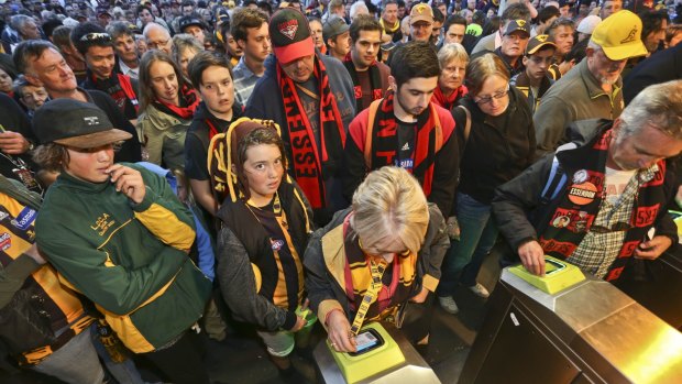Crowds of people line up at Richmond station as fans are forced to swipe their myki cards.