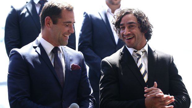 Friendly rivals: Cameron Smith and Johnathan Thurston share a joke on stage during the 2016 NRL season launch at Sydney Botanical Gardens.