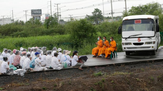 Monks and worshippers block the road outside the Dhammakaya Temple, north of Bangkok, last year.