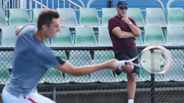 Focus and discipline:  Bernard Tomic hits a forehand in front of his dad John during practice.