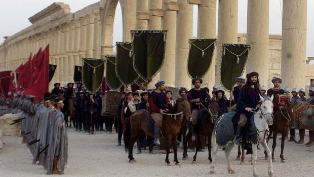 In this 2002 file photo, a symbolic trade caravan representing the prosperous trade during the era of Queen Zenobia AD260-AD273 attend a show in the ancient city of Palmyra.