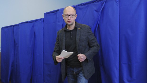 Ukrainian Prime Minister Arseniy Yatsenyuk leaves a voting cabin at a polling station in Kiev on Sunday.