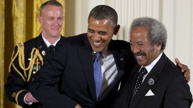 US President Barack Obama welcomes Allen Toussaint  to award him the 2012 National Medal of Arts for his contributions as a composer, producer, and performer, during a ceremony in the East Room of White House in Washington.