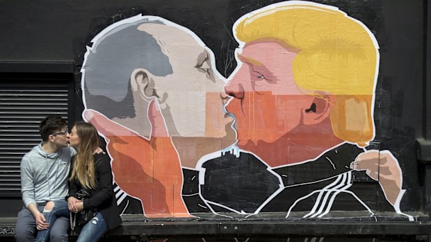 A mural on the walls of a bar in Vilnius, Lithuania, depicts Russian President Vladimir Putin and Republican President-elect Donald Trump kissing.