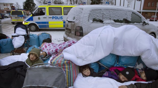 Syrian refugee children sleep outside the Swedish Migration Board in Marsta, Sweden, in January.