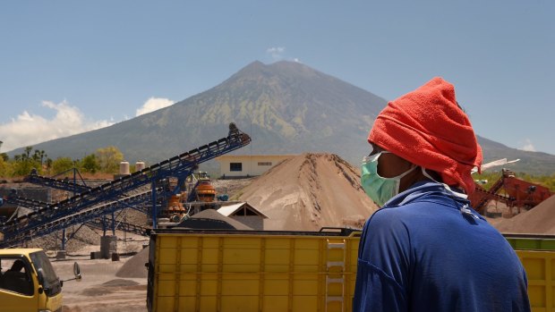 Inside the exclusion zone, day labourers works at the PT Bhale Dana mine in Kubu, at the base of Mount Agung in Bali.