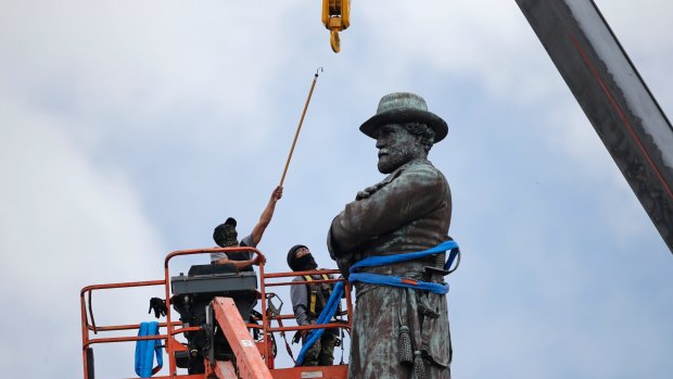 Workers prepare to take down the statue of Confederate general Robert E. Lee in New Orleans in May.

