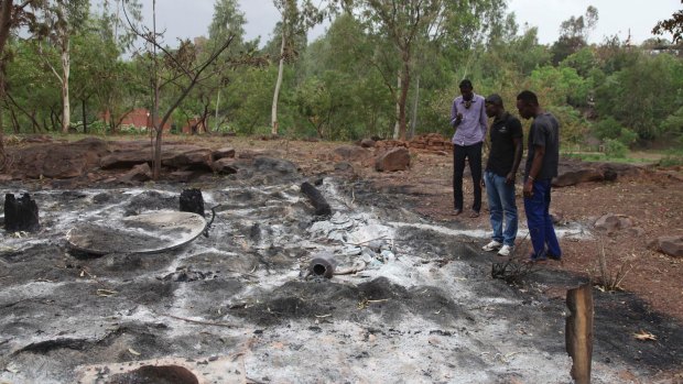 Locals look at the burnt Campement Kangaba, a resort popular with foreigners near Bamako, after it was attacked by Islamist militants in June. 