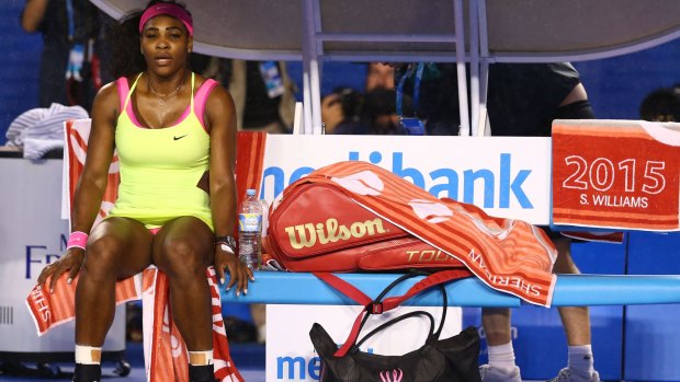 Serena Williams waits for the roof to be closed after it began to rain.