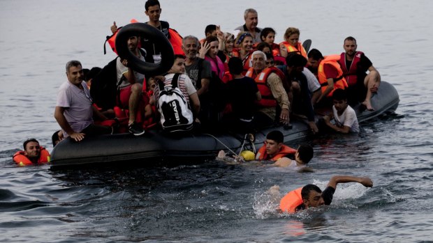 Syrians arrive on a dinghy after crossing from Turkey to Lesbos island in Greece on Wednesday.