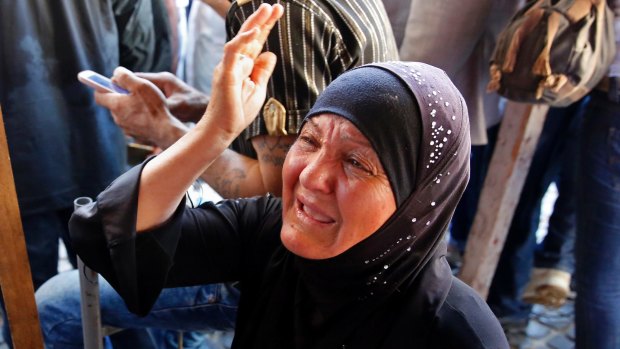The mother of Mustafa Ali Wehbe, who was kidnapped by IS, weeps. Bodies believed to be of kidnapped soldiers have been found buried near the Lebanese border with Syria.