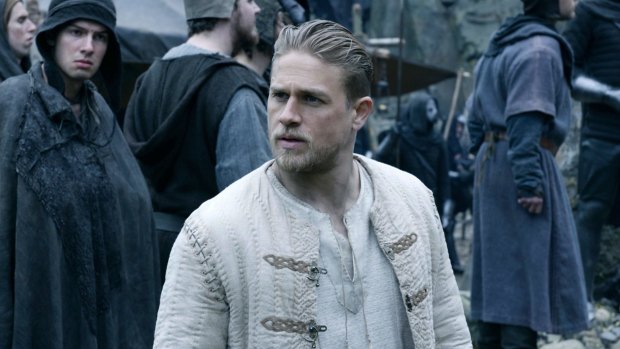Charlie Hunnam portrays the young Arthur as an amiable chancer in King Arthur: Legend of the Sword.