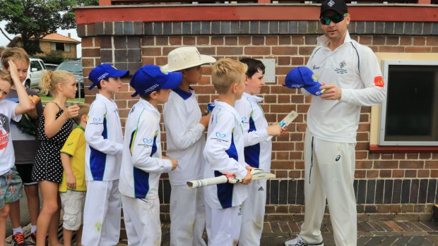 Junior cricketers didn't miss their chance for an autograph.