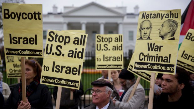 Demonstrators opposed to Israeli PM Benjamin Netanyahu hold signs outside of the White House before his meeting Barack Obama in Washington in November.