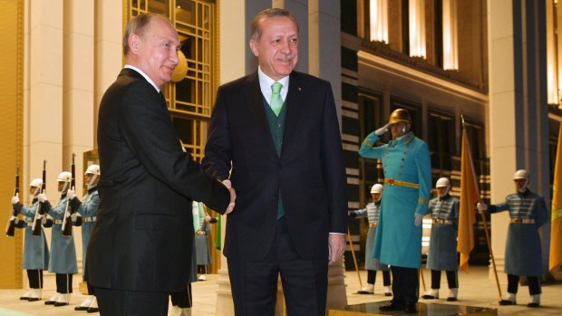 Vladimir Putin, left, shakes hands with Recep Tayyip Erdogan prior to their meeting at the Presidential Palace in Ankara, Turkey, on Monday.