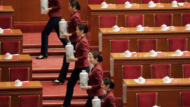 Attendants serve tea ahead of the opening of the 19th National Congress of the Communist Party