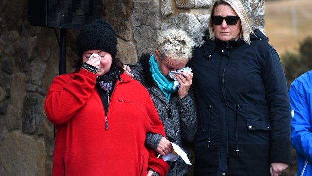 Mourners Donna Barlow (L) and Wendy Hukins (C) at a memorial service at the Thredbo Ecumenical Chapel on Sunday. 