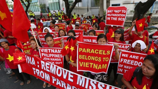 Filipinos and Vietnamese expatriates rally last Thursday at the Chinese consulate in Makati, east of Manila, to protest China's island-building and deployment of surface-to-air missile system in the South China Sea.