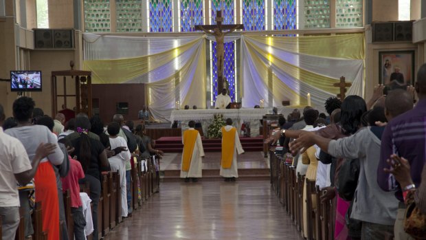 Kenyan Christians pray as they join a morning service at Holy Family Basilica in Nairobi on Sunday.