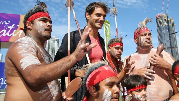 Roger Federer with representatives of the Nunukul Yuggerah indigenous dance group after a traditional welcome to country ceremony ahead of the Brisbane International on Saturday.