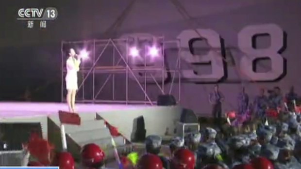 A singer performs for Chinese navy officers and construction workers on Fiery Cross Reef in the South China Sea. 