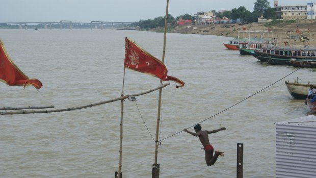 A boy jumps into the Ganges River in at Varanasi.