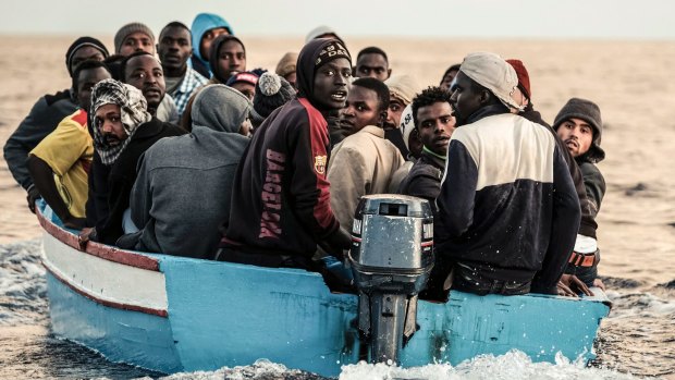 Migrants on a small wooden boat wait to be rescued by the German non-profit organisation Sea Watch, in the central Mediterranean Sea last week.