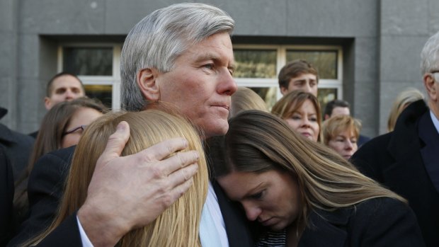 The former Virginia governor hugs his daughters Cailin Young, left, and Jeanine McDonnell Zubowsky outside court.
