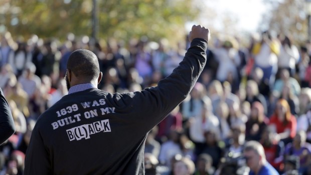 A member of the black student protest group Concerned Student 1950 gestures while addressing a crowd on Monday, following the announcement that University of Missouri president Tim Wolfe would resign.