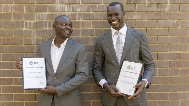 Taxi passengers John Akuak and Goch Kot received awards for their actions in stopping Imran Hakimi's attack.