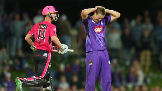 Honest toiler: Joe Mennie looks unhappy after a missed chance off his bowling for Hobart against the Sixers.