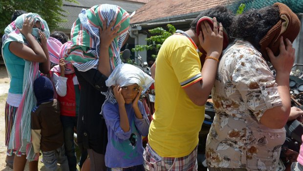 Sri Lankan asylum seekers sent back by Australia in July enter court in Galle, Sri Lanka.