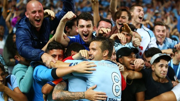 Seeing blue: Sydney FC fans celebrate Corey Gameiro's opener against Melbourne City last weekend.