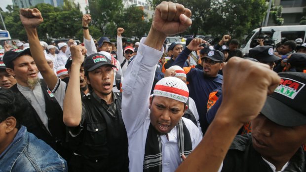 Muslim protesters shout slogans during a rally outside court on Tuesday.