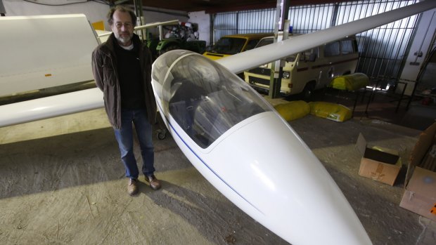 Aviation club member Peter Ruecker stands beside a glider that was flown by Andreas Lubitz in the hangar of the club in Montabaur, Germany on Thursday.
