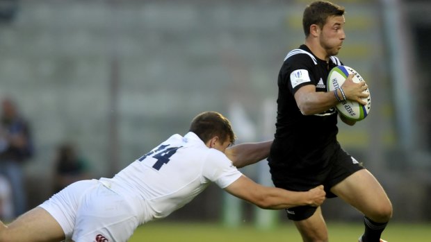 New Zealand's Hamsih Dalzell, right, is tackled by New England's George Perkins.