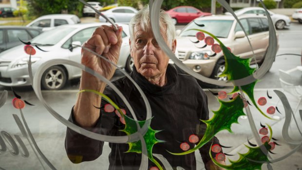 Robbie Holbery paints Christmas messages in butcher shop windows across Victoria.