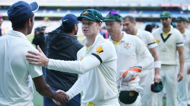 The Australian and Indian teams shake hands after the third Test ended in a draw.