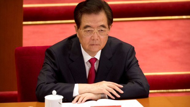 Former Chinese president Hu Jintao listens to Xi Jinping's speech.