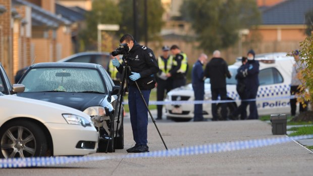 Police and forensic officers at the scene of the shooting in Church Road, Keysborough.