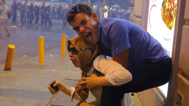 Tear gas used by riot police  dispersed demonstrators in Istanbul. The protesters blamed the Suruc blast on lax government action on Islamic State. 