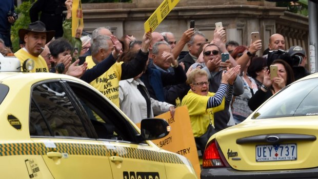 Taxi owners protesting at Parliament House on Monday.