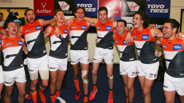 Finals bound: Giants players sing the club song after winning their round 23 match against North Melbourne.