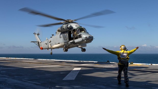 A Seasprite helicopter lands on HMAS Canberra's flight deck during the Talisman Sabre military drills.
