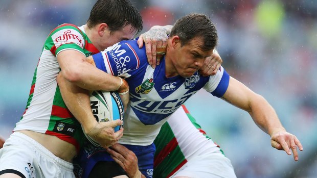 Casualty: Brett Morris is halted by the Rabbitohs defence.